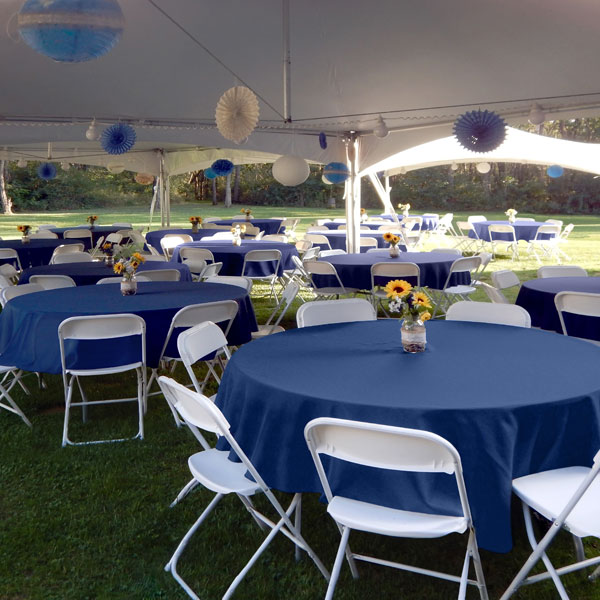 tables and chairs setup under tent for event