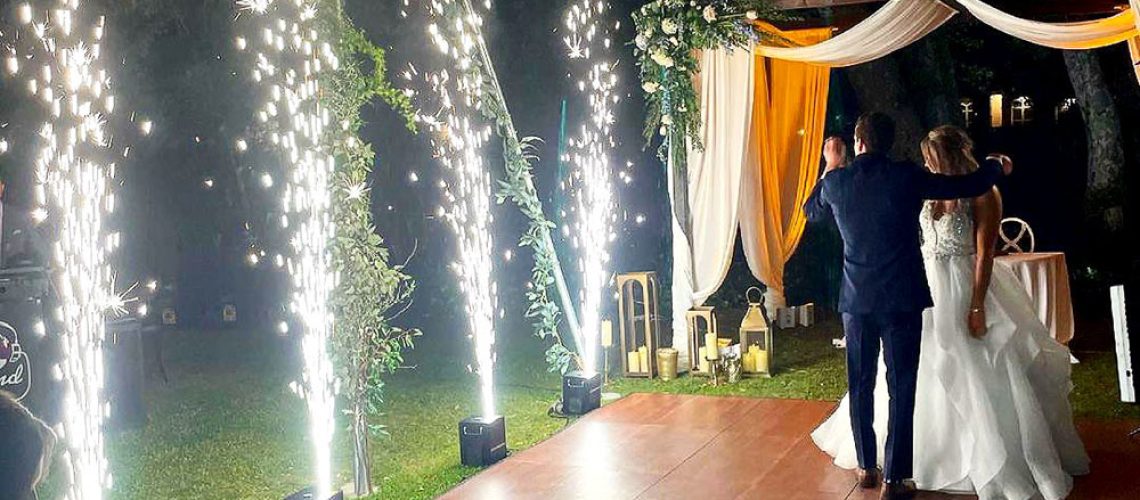 Dark maple dance floor and fireworks at a wedding